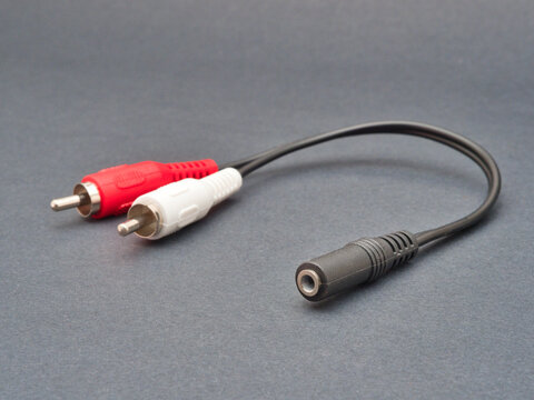 RCA to 3.5mm Jack Audio Adapter - Close-up studio shot of an RCA to 3.5mm jack audio adapter, featuring red and white male RCA plugs and a female 3.5mm stereo jack.