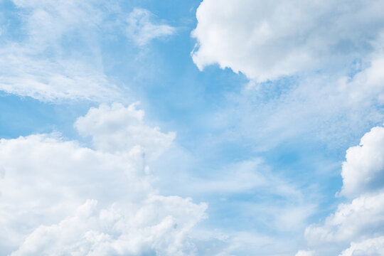 Blue sky with fluffy white cumulus clouds as a sunny weather backdrop
