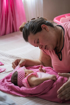 Mother cradling newborn infant with loving care
