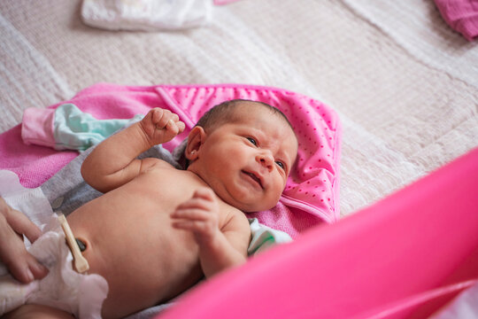 Newborn infant receiving care during a diaper change