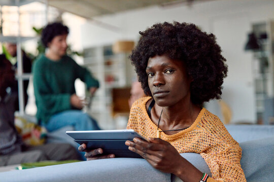 Young woman holding a tablet in a modern workspace