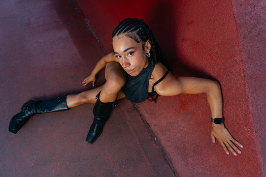 Young Woman Posing Against Red Wall