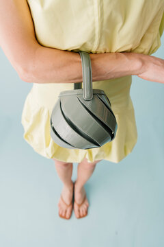 Stylish Green Handbag Held Over Yellow Dress
