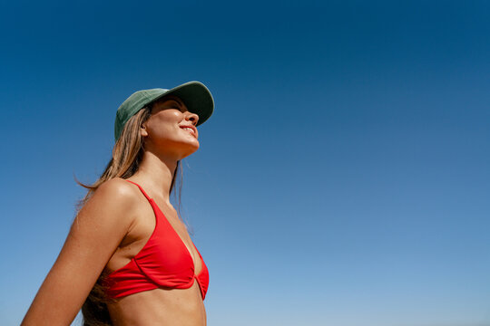Smiling Person in Red Swimsuit