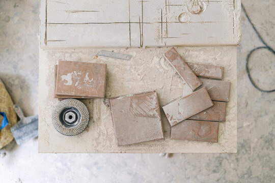 Dusty Ceramic tiles and tools on workbench