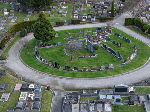 Ferntree Gully, Australia - 09 September 2026: Aerial view of Ferntree Gully Cemetery featuring circular pathways, manicured lawns, and various headstones and monuments.