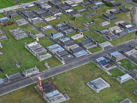 Ferntree Gully, Victoria, Australia - 09 September 2026: Aerial view of Ferntree Gully Cemetery with rows of gravestones, stone monuments, and pathways set within a grassy landscape.
