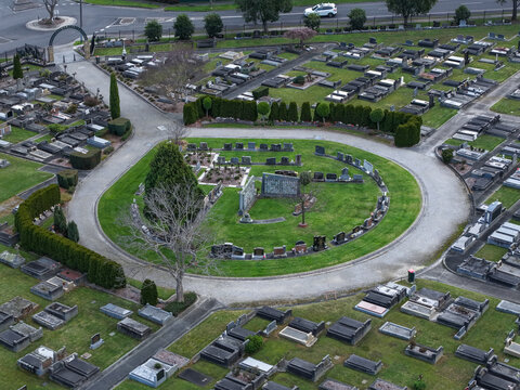 Ferntree Gully, Victoria, Australia - 09 September 2026: Aerial view of Ferntree Gully Cemetery with a circular path surrounding gravestones, manicured lawns, and trimmed hedges.