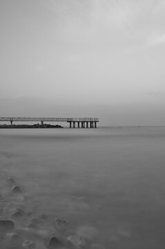 Paisaje mar&iacute;timo minimalista en blanco y negro de la pasarela de Xilxes con efecto seda, Espa&ntilde;a
