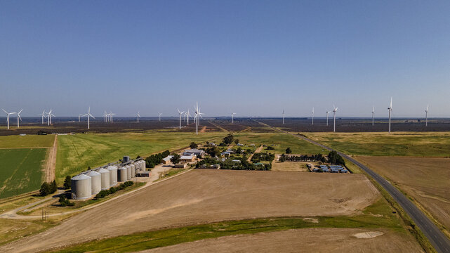 Hopefield, Western Cape, South Africa - 08 September 2026: Aerial view of the Hopefield wind farm with numerous wind turbines, agricultural fields, and grain silos.