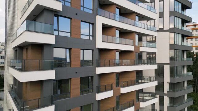 Modern Residential Building Facade with Balconies and Wooden Panels