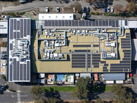 Wantirna South, Australia - 08 September 2026: Aerial view of Waverley Christian College, showing extensive rooftop solar panel arrays, complex HVAC ventilation systems, and school grounds.