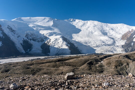 Snow-covered north face of Lenin Peak near Camp 1 under clear blue sky  in August