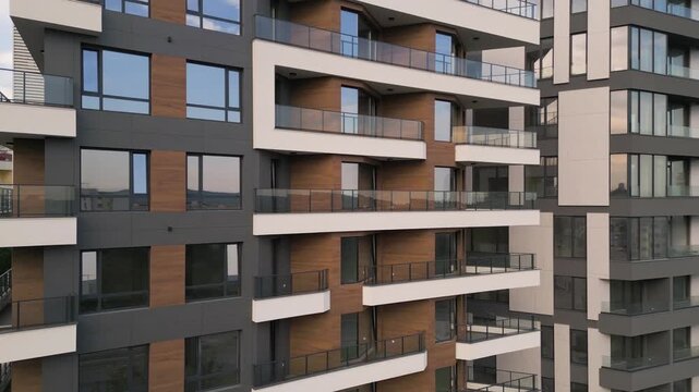 Modern Residential Building Facade with Balconies and Wooden Panels