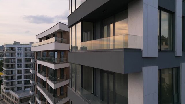 Modern Residential Building Facade with Balconies and Wooden Panels