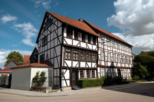 Wolfenbuttel, Germany - July 3, 2026: Weathered timber-framed house with exposed brick infill stands along a narrow street in the historic old town.