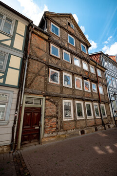 Wolfenbuttel, Germany - July 3, 2026: Weathered timber-framed house with exposed brick infill stands along a narrow street in the historic old town.