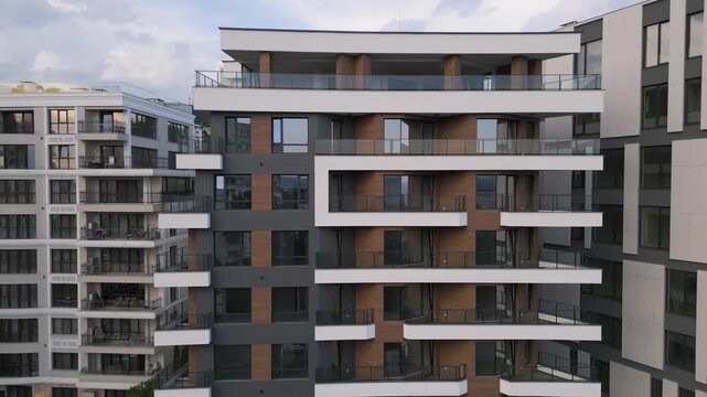 Modern Residential Building Facade with Balconies and Wooden Panels