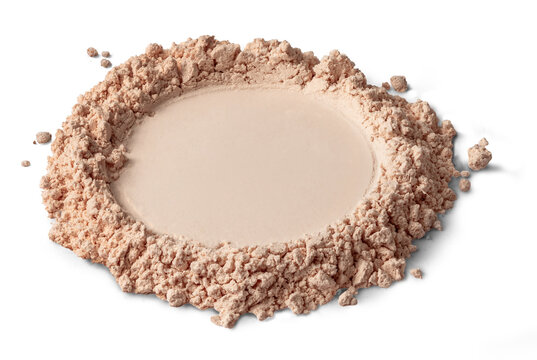 Loose beige face powder loose pile with compact circular center and scattered crumble, on white background neutral matte texture