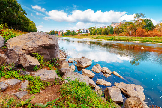 urban landscape with city park and a river in front. beautiful autumn scenery of Uzhhorod Orthodox embankment. vacation background with sky reflection on the water. fall season in Urkaine