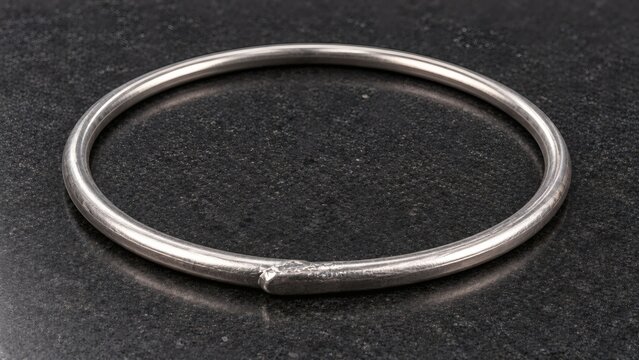 Curated Loop of Pure Soft Metallic Indium Wire Cryogenic Gasket on Dark Basalt