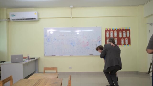 Teacher explaining lesson at classroom board