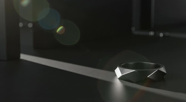 Luxury ambient dark art wallpaper: cinematic slow motion of a matte titanium black geometric ring with over 80% negative space, catching a single razor-sharp sunlight shadow 