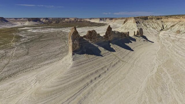 Aerial flight over arid rock ridge formation in desert landscape