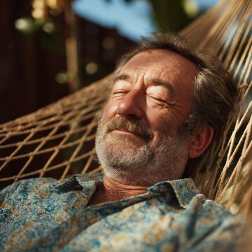 Senior Man With Mustache Sleeping Peacefully In Rope Hammock Outdoors