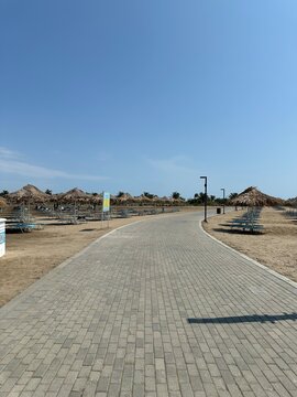 The way to the beach. Bungalow, blue sky, horizon, panorama.