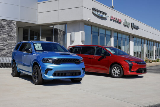 Dodge Durango SUV MY:2026 and Chrysler Pacifica Minivan MY:2027 display at a Stellantis dealership.