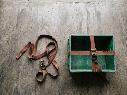 Carrier crate with tie down straps on concrete floor storage and transport