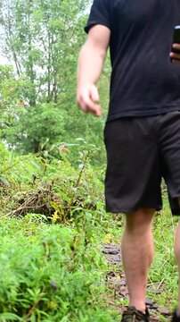 Hiker with a backpack fall season woodland trail, outdoor activities, candid authentic real people