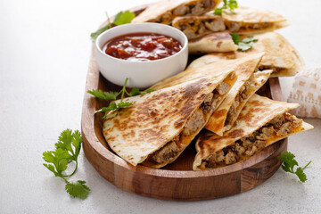 Fototapeta na wymiar Ground beef and cheese quesadillas on a serving plate