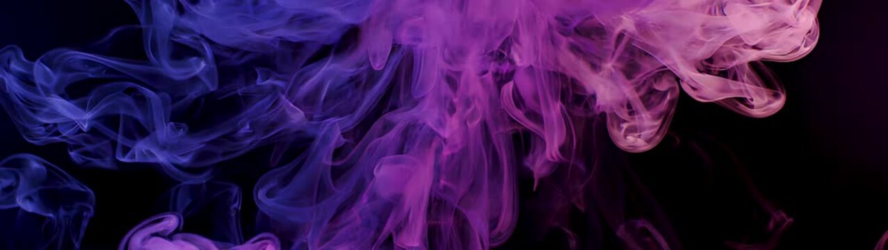Purple and blue smoke spreading and dissolving on a dark background Smoke plumes representing mystery and change.