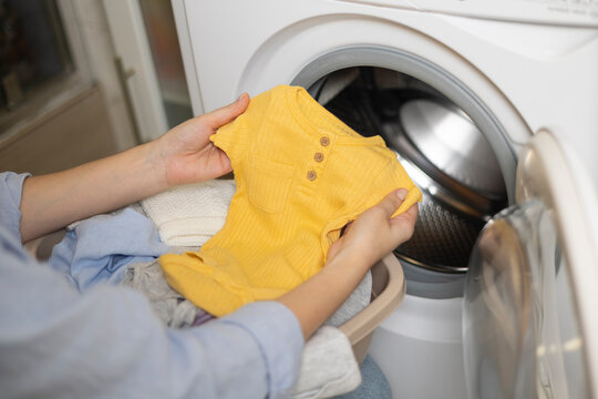 Washing baby clothes in washing machine at home