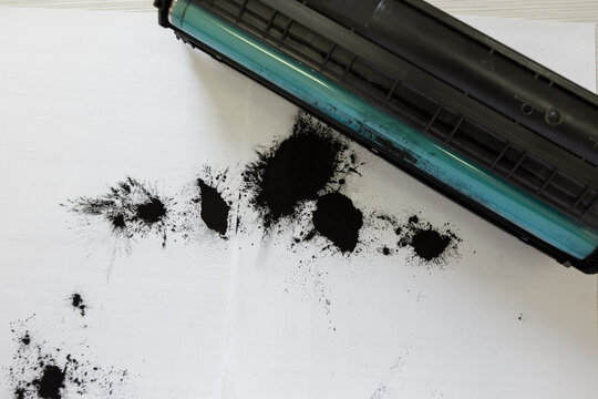 Toner powder spilled out of a broken laser printer cartridge.