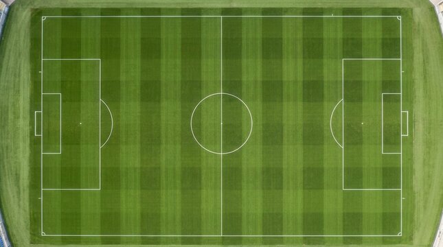 Lush green turf and marked pitch lines of a soccer field from an aerial view