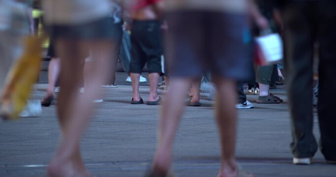 SHANGHAI, CHINA - AUGUST 23, 2026: Low angle view of pedestrian feet and legs walking across a busy city square in SHANGHAI, CHINA, in timelapse