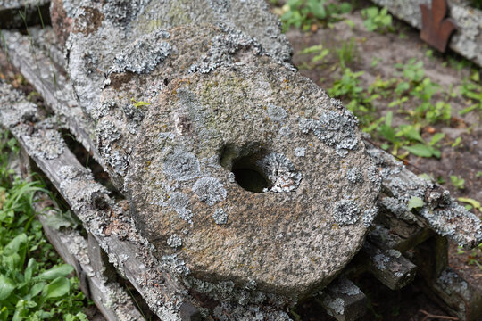 Old Millstones Resting On Wooden Pallets