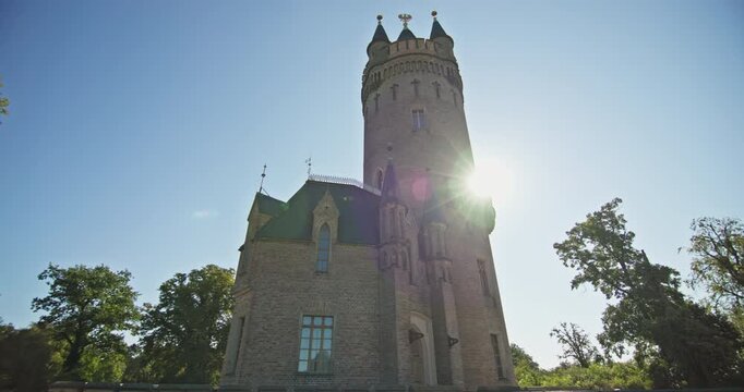 Gothic Revival brickwork and turrets define Flatow Tower in Babelsberg Park, Potsdam, Germany.
