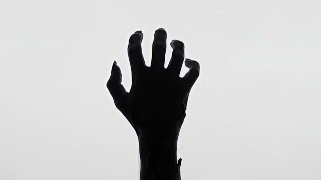Zombie Hand Silhouette Reaching in Slow Motion on White Background