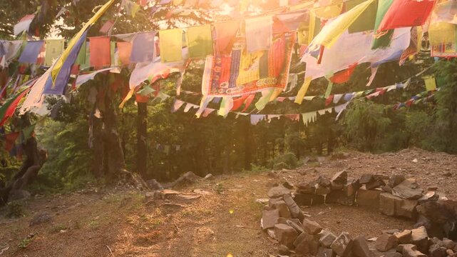 Buddhist prayer flags waving in warm Himalayan mountain light
