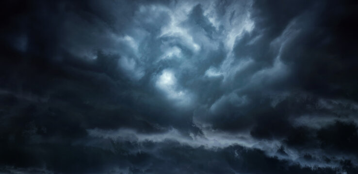Dramatic sky with storm clouds before rain. Panoramic view of the stormy sky and dark clouds.  Concept on the theme of weather, natural disasters.