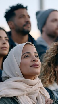 Diverse people looking up together with hope for the future
