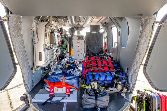 Interior view of a rescue helicopter equipped with medical emergency equipment for search and rescue operations. 
