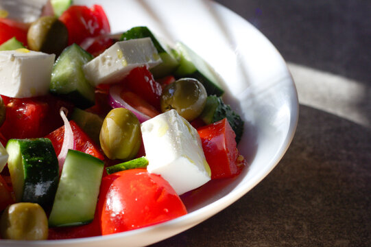 Greek salad with feta cheese and vegetables with copy space