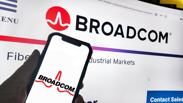 a computer screen and smartphone with broadcom website displayed....Broadcom Inc. is a major global technology company that designs, develops, and supplies semiconductor devices and infrastructure 