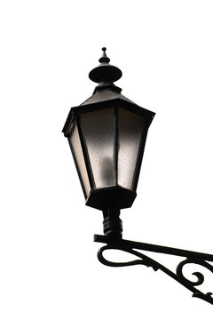 Vintage street lamp. Antique lantern white background. Black metal street light. Wrought iron lantern. Old European street lamp. Classic retro lighting. Isolated lantern object. Vintage lamp post