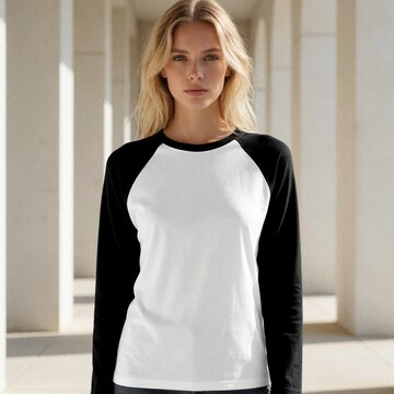 Woman wears blank raglan shirt, black sleeves white front. Model poses outside modern building, ready for custom print design. Casual apparel for teens, adults.